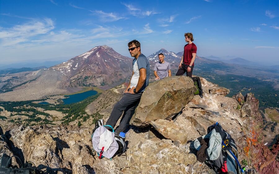Friends taking in a mountain summit view