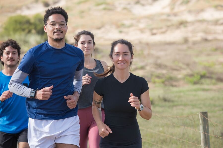 Friends running together outdoors